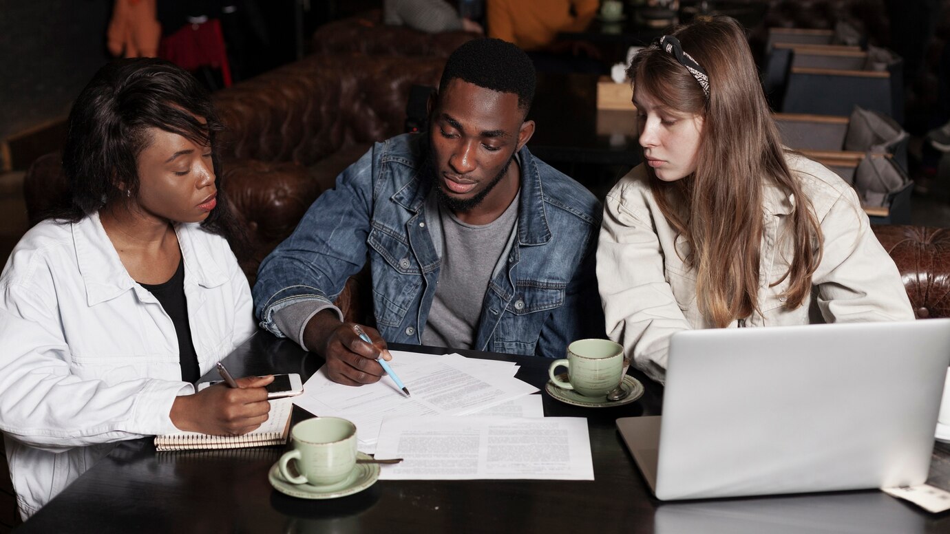 Academic reviewers evaluating papers on desk